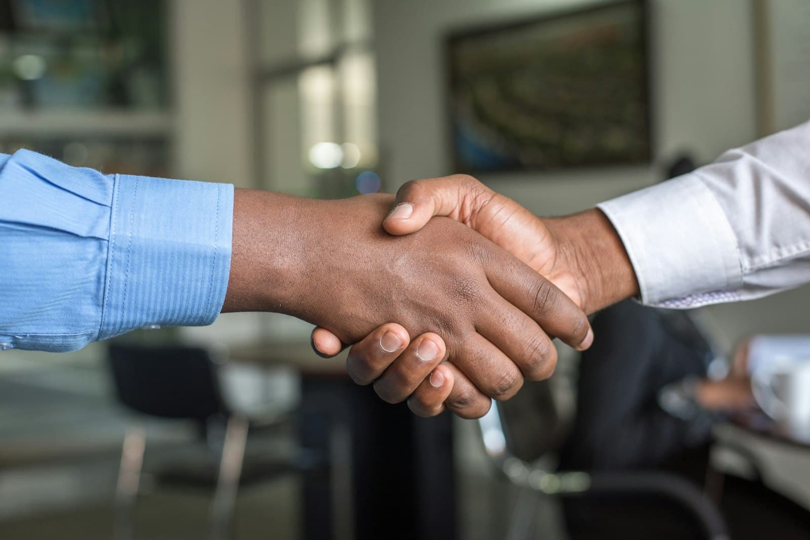 A handshake closing a deal in a conference room